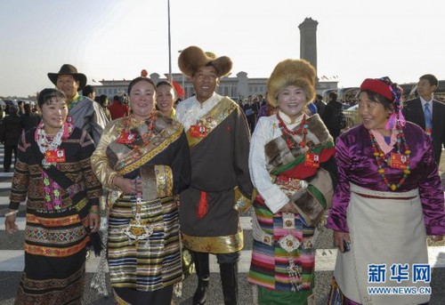 Party secretary of Laxi Township in Nagqu Prefecture in southwest China's Tibet Autonomous Region Amei (L3) and other Tibetan delegates walk across Tian'anmen Square to attend the 18th CPC National Congress on November 8, 2012. [Xinhua]