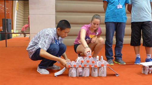 Children participate in a bridge building contest at the Bluestar International Summer Camp. [Women of China/Yao Yao]