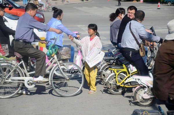 Brave Girl Sells Newspapers to Support Stricken Family