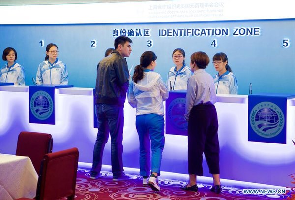 Volunteers Work at Registration Center for 18th SCO Summit in Qingdao