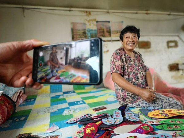 Woman Official Records Villagers' Improved Lives Through Her Lens