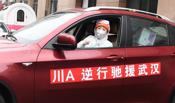 Volunteer Nicknamed 'Raincoat Sister' Cooks and Delivers Food for Medical Workers Fighting Against COVID-19 in Wuhan