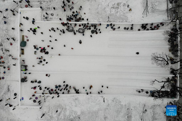 People Enjoy Themselves at Winter Recreation Park in Harbin