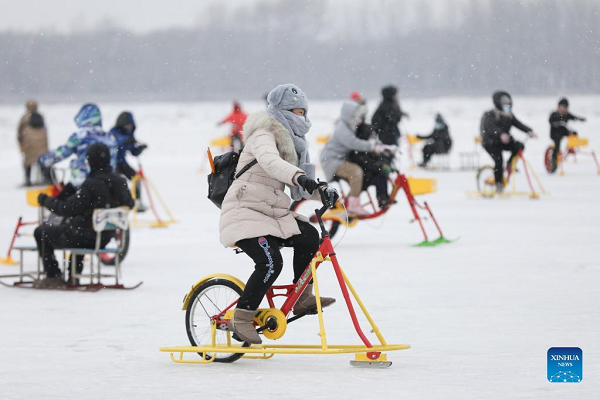 People Enjoy Themselves at Winter Recreation Park in Harbin