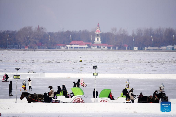 People Enjoy Themselves at Winter Recreation Park in Harbin