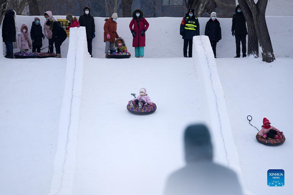 People Enjoy Themselves at Winter Recreation Park in Harbin
