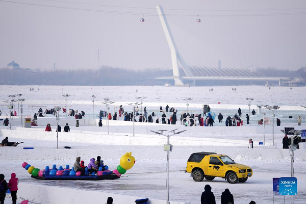 People Enjoy Themselves at Winter Recreation Park in Harbin