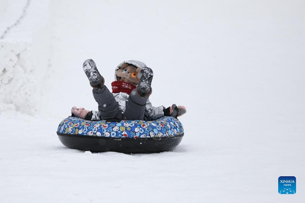 People Enjoy Themselves at Winter Recreation Park in Harbin