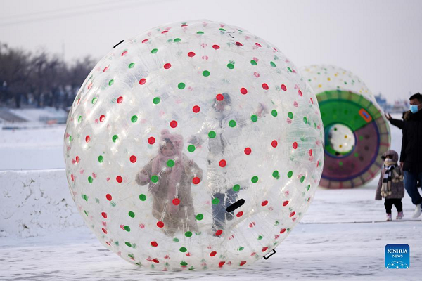 People Enjoy Themselves at Winter Recreation Park in Harbin