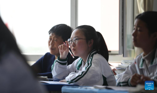 Mother Accompanies Daughter in Studying at School