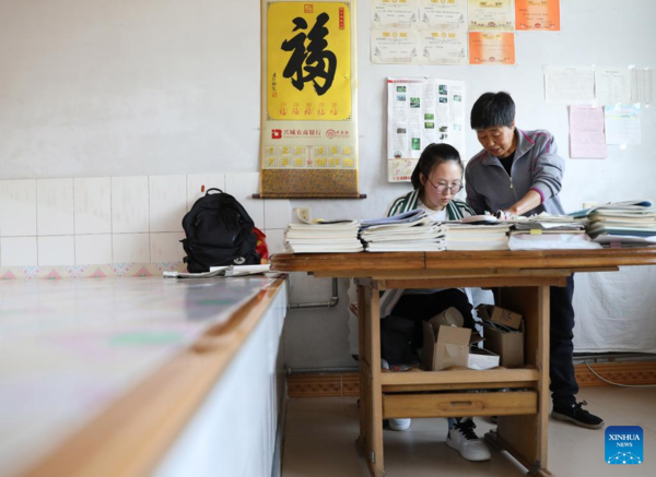 Mother Accompanies Daughter in Studying at School