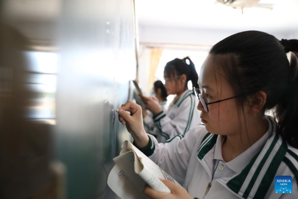 Mother Accompanies Daughter in Studying at School