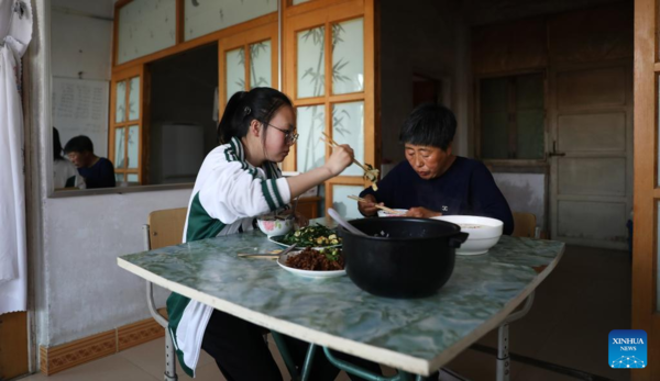 Mother Accompanies Daughter in Studying at School