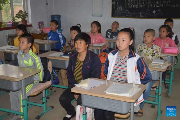 Mother Accompanies Daughter in Studying at School