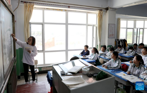 Mother Accompanies Daughter in Studying at School