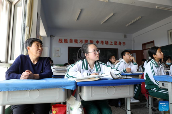 Mother Accompanies Daughter in Studying at School