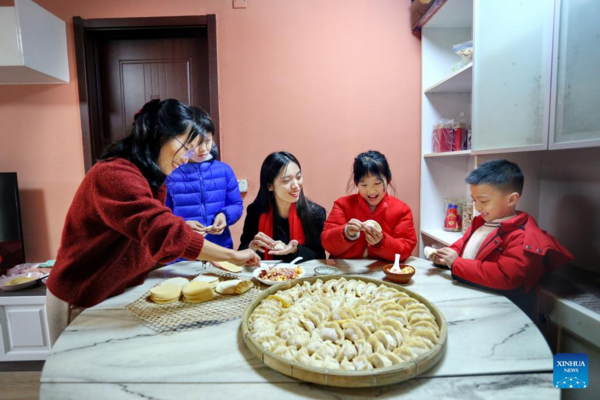 People Across China Have Family Reunion Dinners on Chinese Lunar New Year's Eve